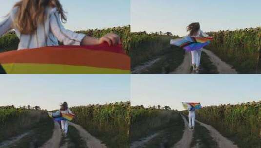 年轻女子在野外奔跑，彩虹LGBTQIA旗高清在线视频素材下载