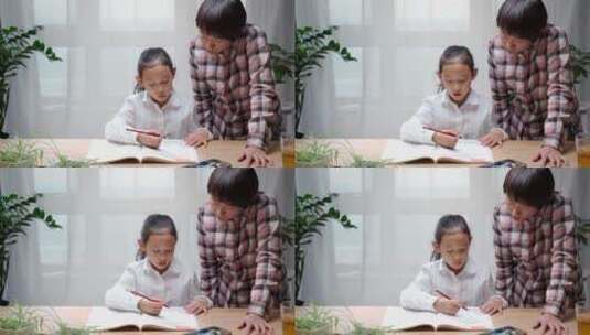辅导孩子写作业的母亲高清在线视频素材下载