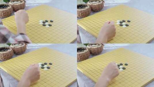 午后对照棋谱学习围棋的中国女性高清在线视频素材下载