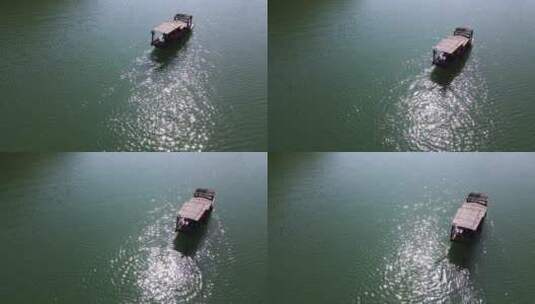 俯拍河中前行的乌篷船摇橹船手摇船波光粼粼高清在线视频素材下载