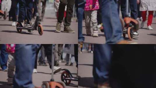 骑在踏板车上的幼儿，两侧是行走的成年人动高清在线视频素材下载