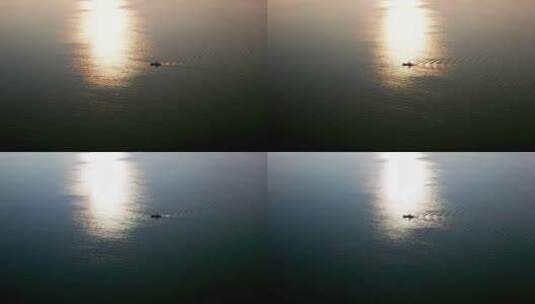 夕阳下平静海面上的渔船高清在线视频素材下载