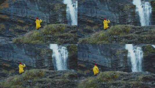 男人独自站在瀑布前拍摄瀑布美景高清在线视频素材下载