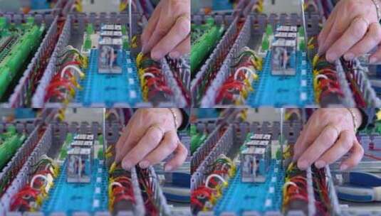 电工在装配线上使用电缆和电线的特写高清在线视频素材下载