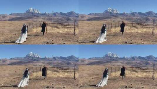 高原枯黄草原走向雪山情侣慢动作拍写真婚纱高清在线视频素材下载