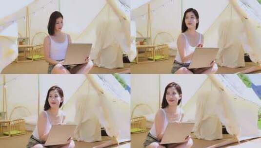 一个美女坐帐篷里使用电脑享受阳光高清在线视频素材下载