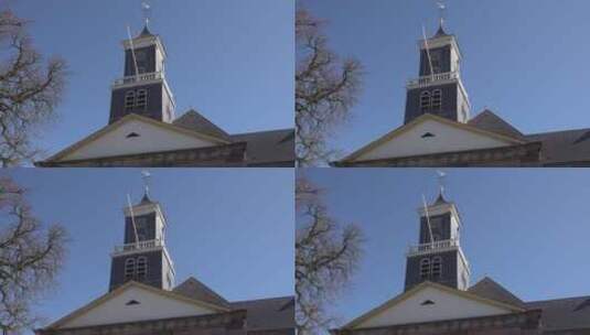 仰拍教堂钟楼上的风向指示器高清在线视频素材下载