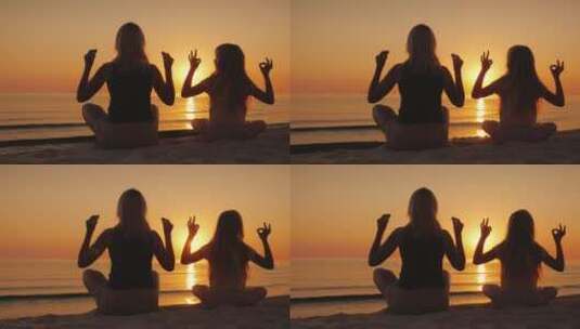 妈妈和女儿在日落时在海边冥想高清在线视频素材下载