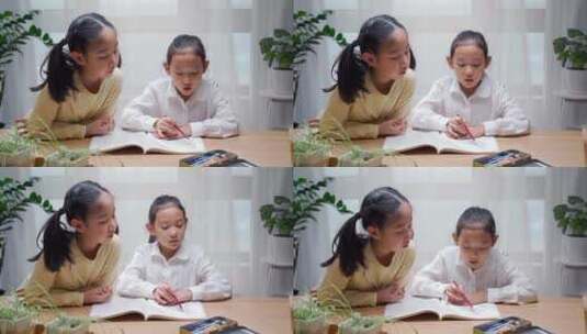 两名学习写作业亚裔女孩高清在线视频素材下载