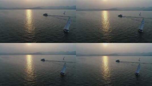 海上游艇帆船向远处航行的日落空镜头高清在线视频素材下载