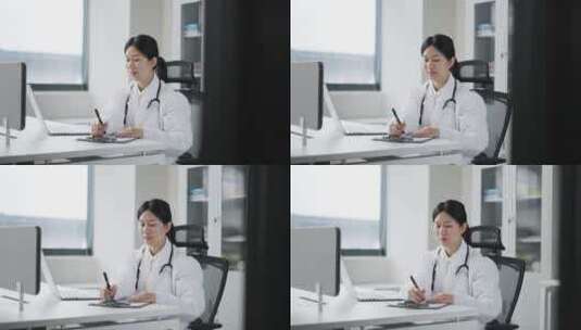 年轻女医生在办公室记录着笔记本里的信息高清在线视频素材下载