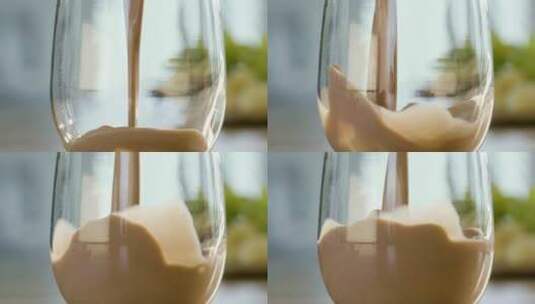 把巧克力牛奶倒进玻璃杯里高清在线视频素材下载