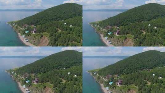 绿色森林和湖上房屋的空中视频片段高清在线视频素材下载