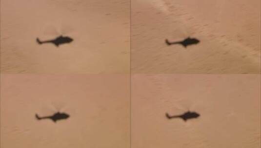飞行直升机在沙漠地板上的阴影高清在线视频素材下载