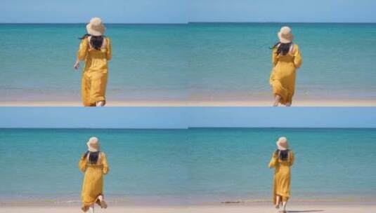 一个黄裙子美女跑向大海高清在线视频素材下载