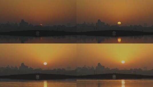 清晨杭州西湖白堤断桥高楼太阳日出延时空镜高清在线视频素材下载
