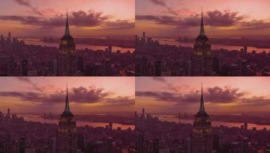 城市航拍飞机从帝国大厦上空飞过日落晚霞高清在线视频素材下载