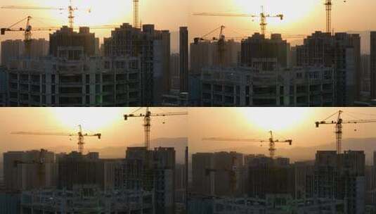 黄昏逆光航拍城市建筑工地塔吊高清在线视频素材下载