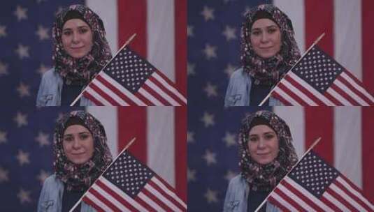 女人微笑着骄傲地举着美国国旗高清在线视频素材下载