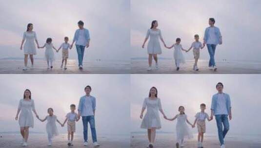 一家人幸福的海边散步高清在线视频素材下载