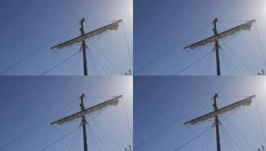 海盗船桅杆和卷起的帆站在晴朗的天空下，阳高清在线视频素材下载