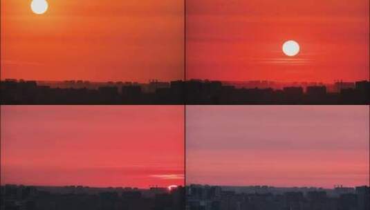 日落时，红色的大太阳落在屋顶后面，延时高清在线视频素材下载