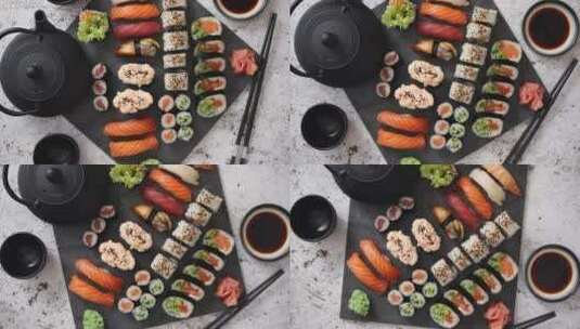 不同种类的寿司卷放在黑色石板上高清在线视频素材下载