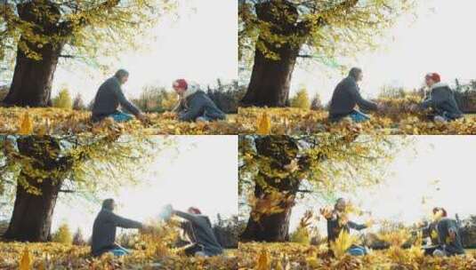 母亲和女儿在公园里扔秋叶高清在线视频素材下载