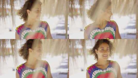 海滩茅草伞下微笑的女人肖像高清在线视频素材下载