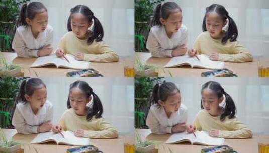 两名学习写作业亚裔女孩高清在线视频素材下载