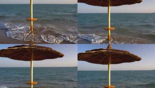 海浪在沙滩伞下翻滚高清在线视频素材下载