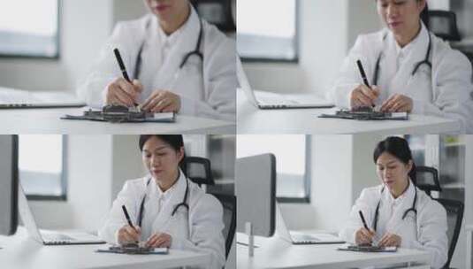 年轻女医生在办公室记录着笔记本里的信息高清在线视频素材下载