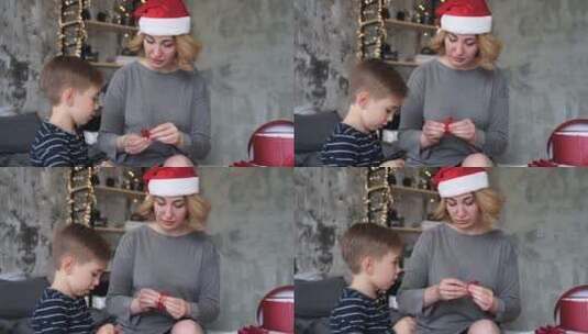 妈妈和儿子准备圣诞礼物丝带高清在线视频素材下载