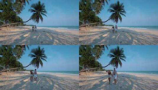 一对夫妇在热带海滩与棕榈树旁游玩高清在线视频素材下载