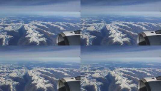 在飞行中透过窗户看飞机，看到白雪覆盖的欧洲阿尔卑斯山r高清在线视频素材下载