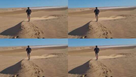 一个人走在撒哈拉沙漠上，留下脚印。高清在线视频素材下载