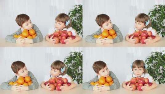 在桌上抱着水果的小孩高清在线视频素材下载