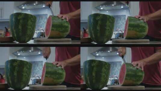 一个人在厨房里用刀切一个大西瓜高清在线视频素材下载