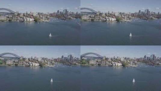 航拍海滨城市和海面的帆船高清在线视频素材下载