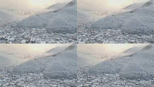 克拉斯纳亚波利亚纳村被白雪覆盖的山脉包围高清在线视频素材下载