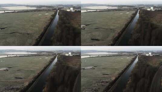 河流沼泽陆地海岸通勤交通过桥英国空中回拉高清在线视频素材下载