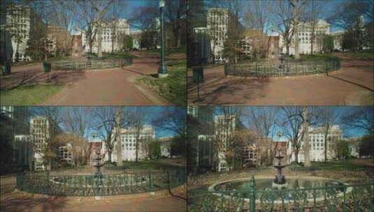 城市公园建筑物和树木旁边的喷泉高清在线视频素材下载