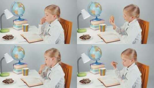 女学生坐在书桌前看书吃巧克力高清在线视频素材下载
