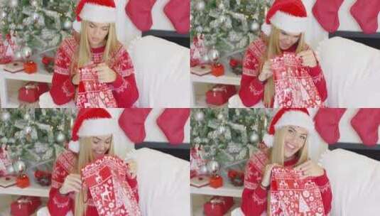 女孩打开自己的圣诞礼物高清在线视频素材下载