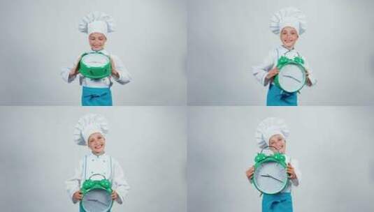 穿着厨师服的孩子拿着闹钟欢笑高清在线视频素材下载