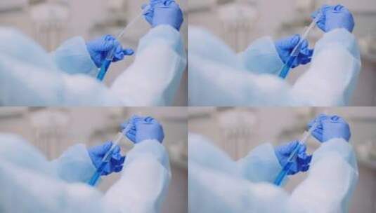 女科学家用滴管吸取试管中的蓝色试剂高清在线视频素材下载