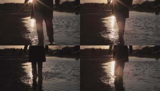 日落时一人在水坑中溅起水花高清在线视频素材下载