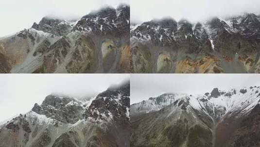 阴天航拍云雾覆盖的雪山高清在线视频素材下载