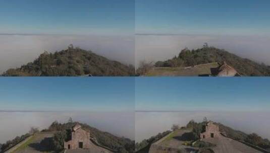 飞过蒙萨拉兹城堡的历史遗迹，山丘周围有云倒置。高清在线视频素材下载