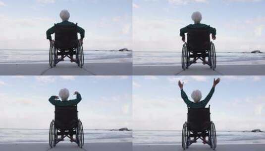 坐在轮椅上的老奶奶在海边张开双臂放松高清在线视频素材下载